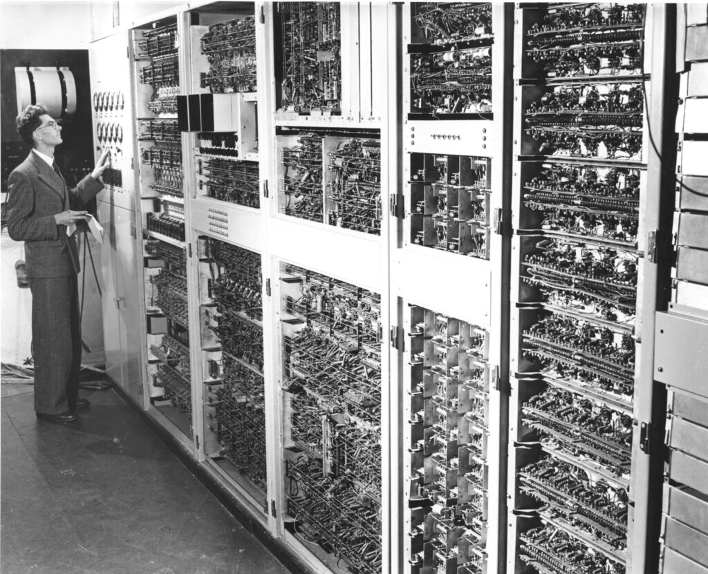 One of CSIRAC's creators Trevor Pearcey, surveying the CSIRAC machine (1952).