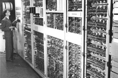 One of CSIRAC's creators Trevor Pearcey, surveying the CSIRAC machine (1952).